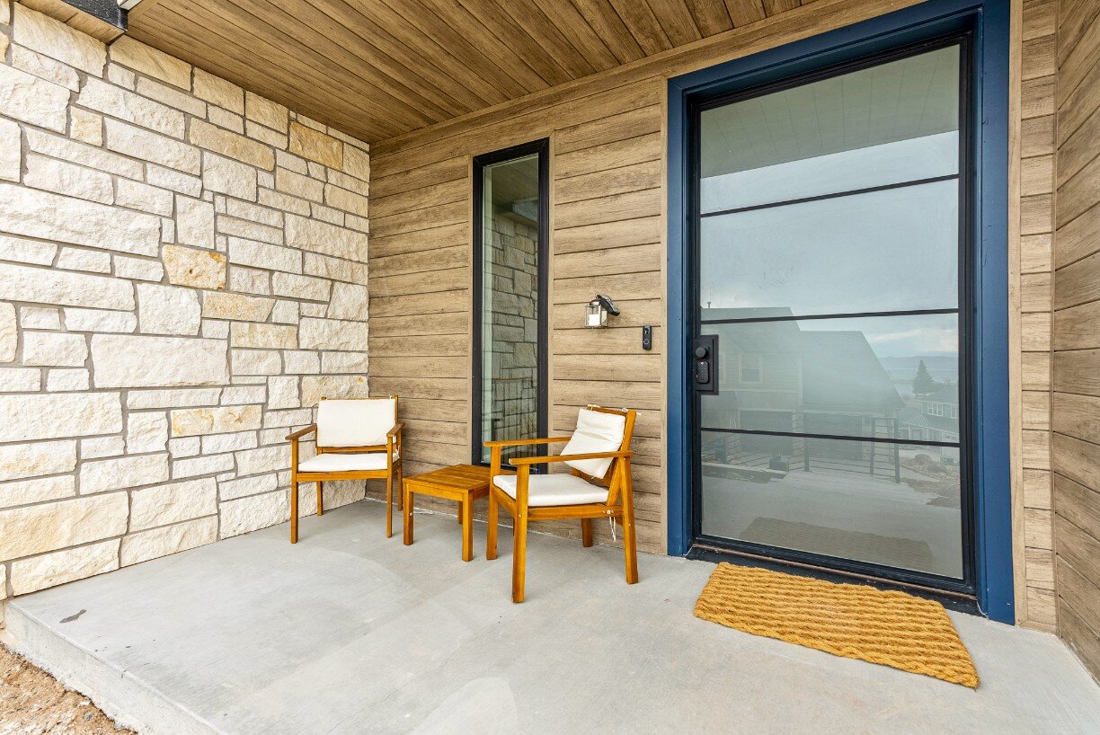 Front Porch Sitting Area Next to Front Door and House Window of Bear Lake Custom Home by 10X Builders