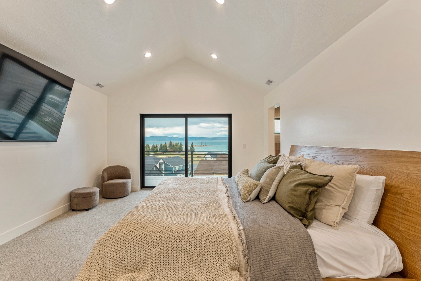 Master Bedroom with Balcony and Television in Bear Lake Custom Home by 10X Builders