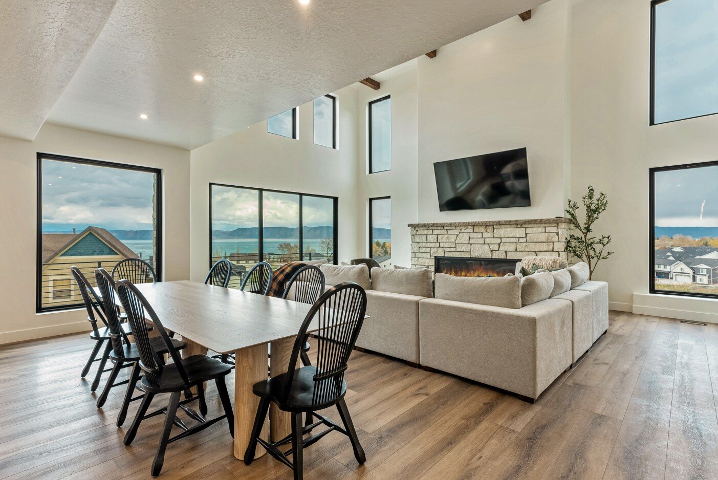 Dining Area and Open Living Room with Large Windows in Bear Lake Custom Home by 10X Builders