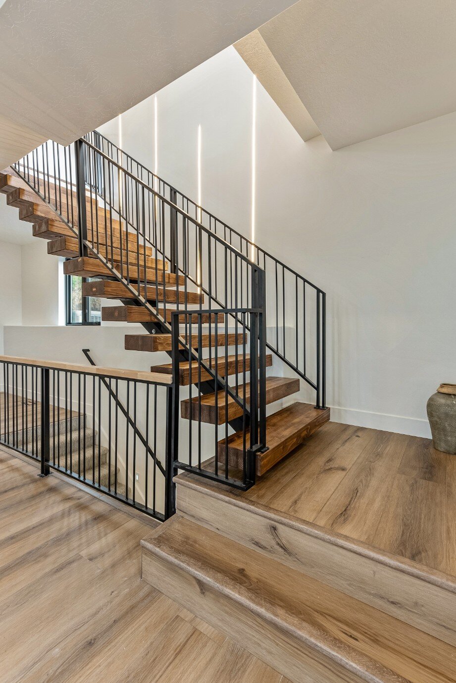 Stairwell into Main Floor in Bear Lake Custom Home by 10X Builders (Portrait)