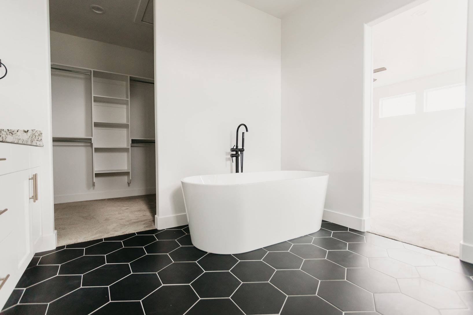 free standing tub with black & white tile by 10x builders in utah county